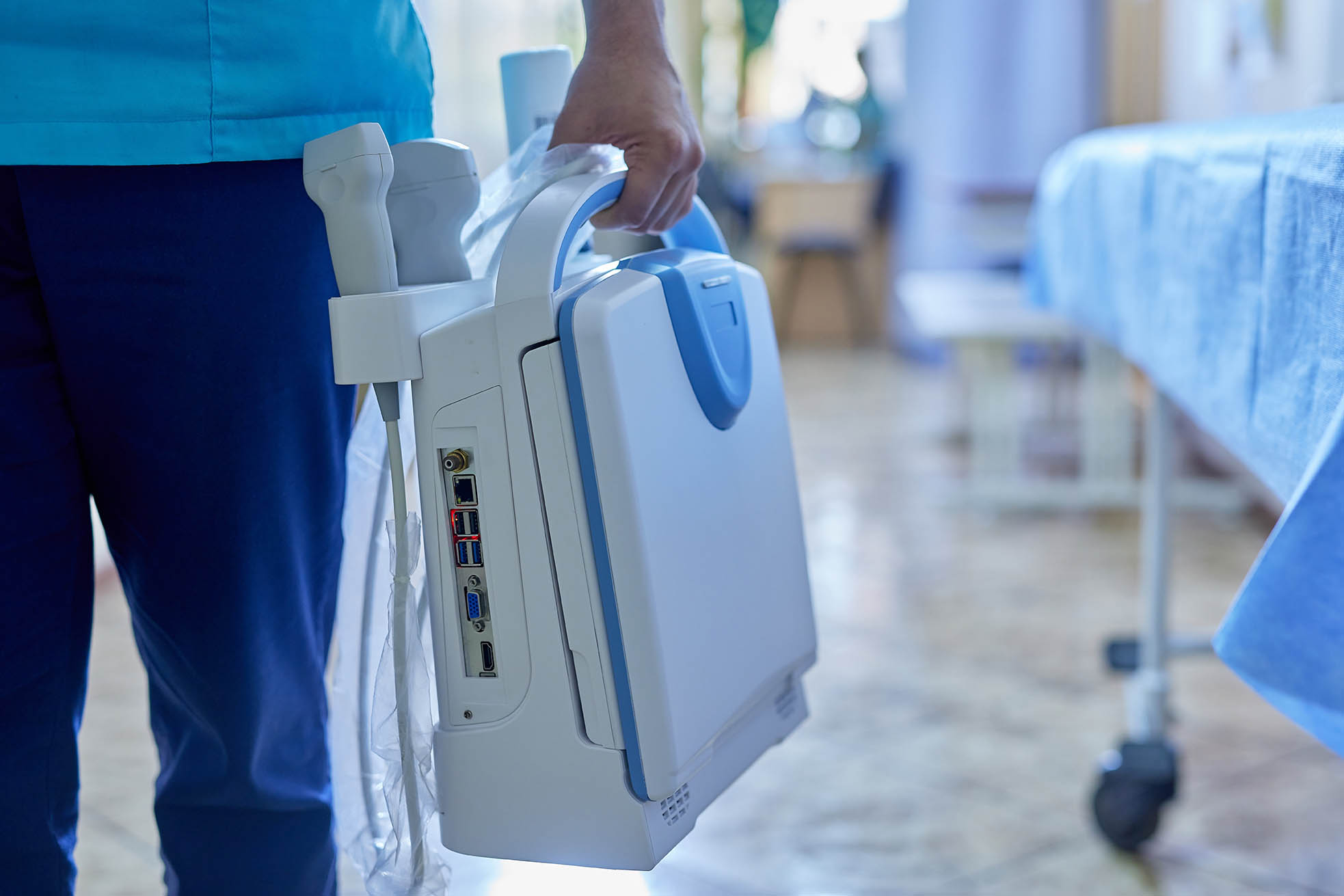 doctor holding mobile ultrasound machine in hospital, mobile ultrasound machine, selective focus